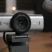 Logitech Brio 4K webcam on a desk with a podcast microphone.