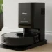 Black Roborock S8 Pro Ultra robot vacuum docked in its RockDock Ultra station, against a light wall in a modern home.