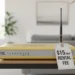 Yellow ISP internet router on a wood desk with a white price tag showing a 15 dollar monthly rental fee