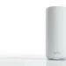 White Netgear Orbi mesh router unit standing on a white surface against a bright white studio background.