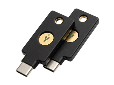 Two YubiKey 5C NFC passkey security keys with USB-C connectors and gold touch sensors