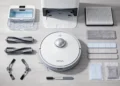 Top view of Mova V50 Ultra robot vacuum with dock, brushes, filters, mop pads, and accessories arranged on the floor.