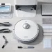 Top view of Mova V50 Ultra robot vacuum with dock, brushes, filters, mop pads, and accessories arranged on the floor.
