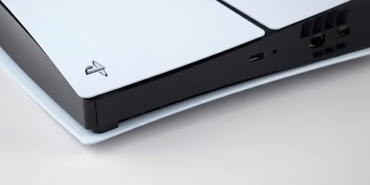 A close-up photograph captures the white outer panel and black center strip of a PlayStation 5 console on a neutral background.