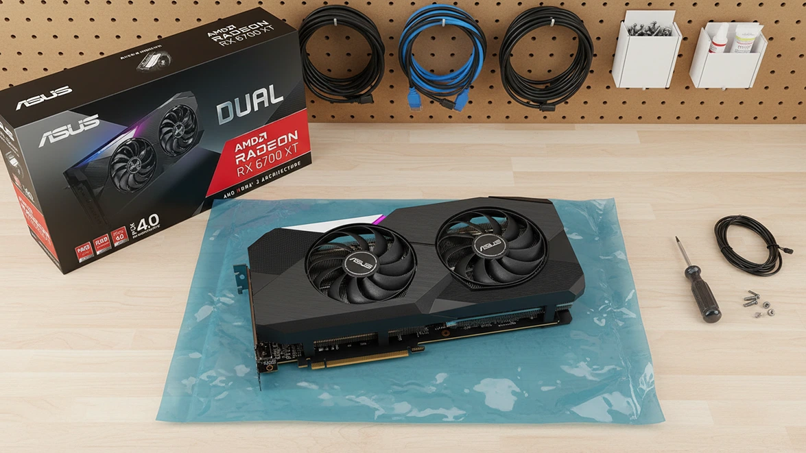 Top-down view of Asus RX 6700 XT on anti-static bag and box on PC workbench.