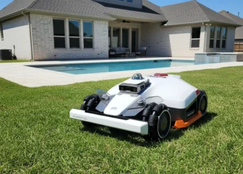 Luba 3 robotic lawn mower on a North Texas suburban lawn near a backyard swimming pool in Frisco.